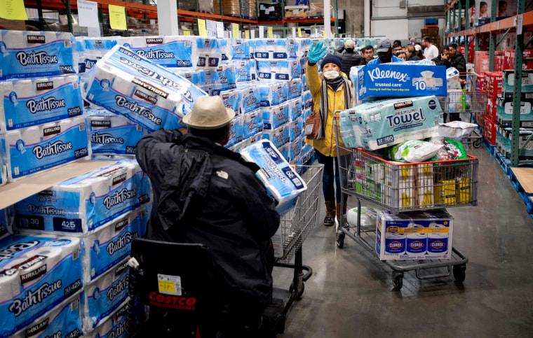 Image: People shop for toilet paper and other provisions at a Costco store in Novato, Calif., on March 14, 2020.