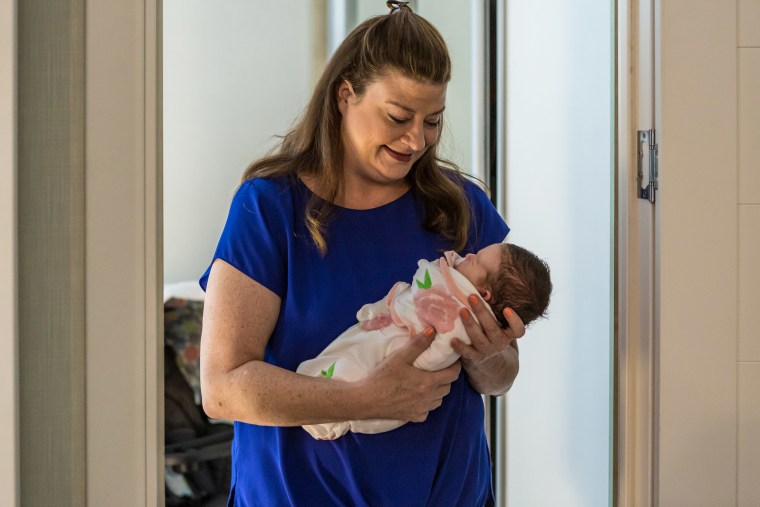 Image: Darlene Straub, 45, the new mother of a newborn baby Sophia, born via surrogacy, holds her in a rented apartment in Kyiv, Ukraine