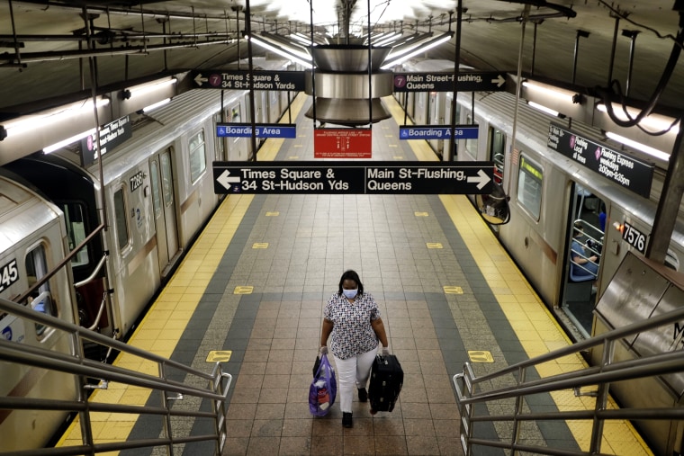 Image: A commuter on a nearly empty subway platform in New York on June 8, 2020.