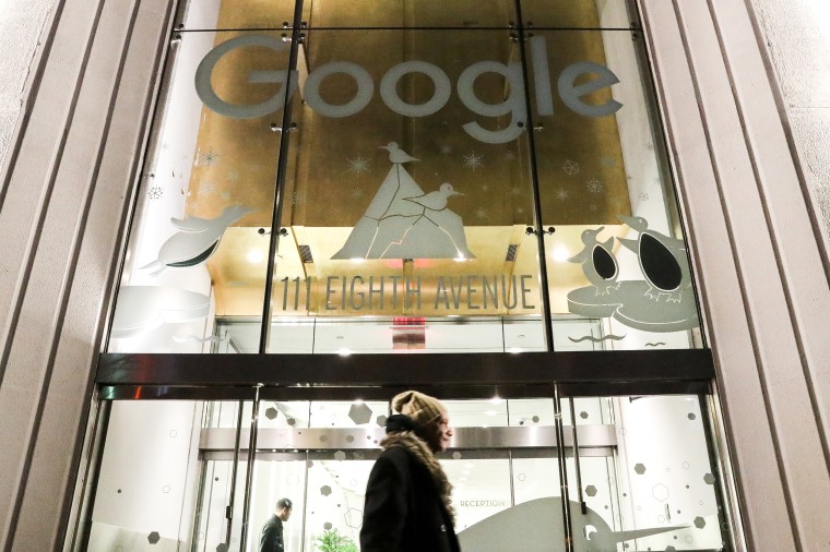 Image: A pedestrian walks past Google headquarters in New York City