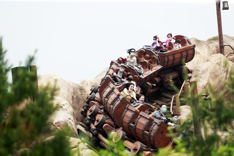 Image: Riders wearing face masks are seen on the Seven Dwarfs Mine Train at Shanghai Disney Resort after the coronavirus pandemic on May 11, 2020 in Shanghai, China.
