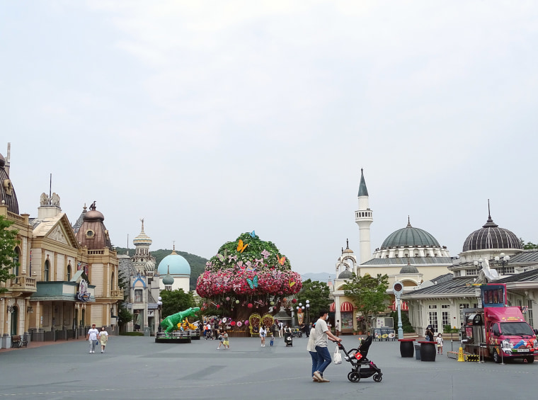 A couple and their baby at the entrance to Everland amusement park in South Korea.