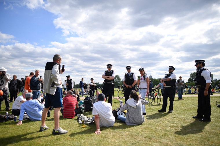 Image: Police officers disperse people who are gathered for an anti-coronavirus lockdown demonstration in Hyde Park in London