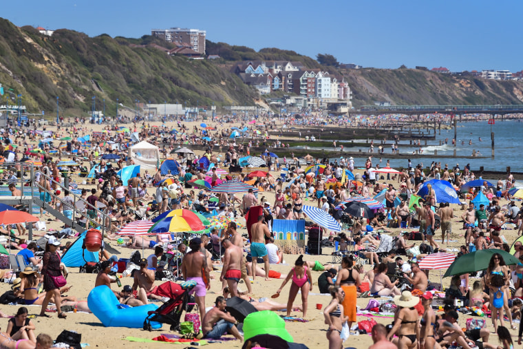 Image: Tourists enjoy the hot weather at Bournemouth beach on May 25, 2020 in Bournemouth, United Kingdom.