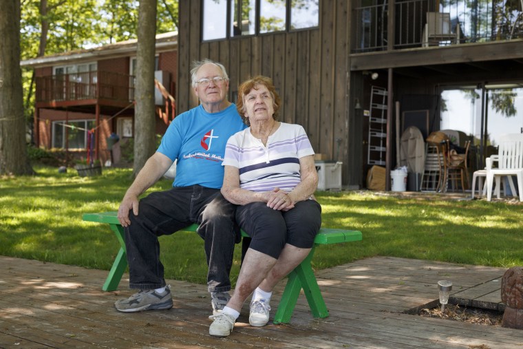 Mike and Judy Gorthy sit in their backyard which reaches to the edge of the nearly empty Sanford Lake on June 2, 2020, in Sanford, Mich.