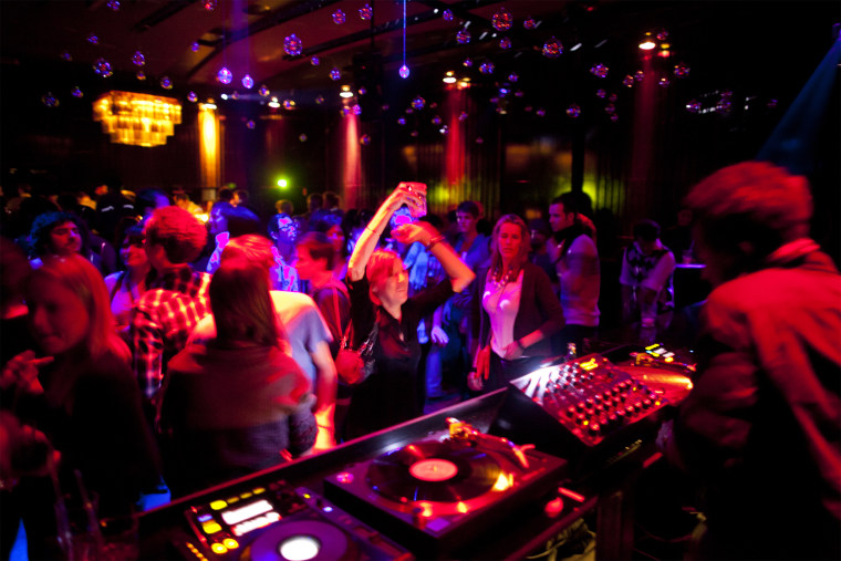 Image: Visitors dancing on the dancefloor of the club "Cookies Cream" in Berlin, Germany.