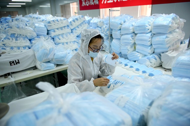 Image: An employee makes face masks on a factory production line in Shenyang, China, on May 16, 2020.