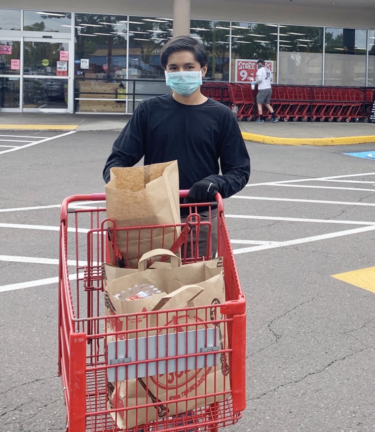 Teenager Neel Jain purchases groceries to deliver to senior citizens in the Portland, Oregon, metropolitan area. 