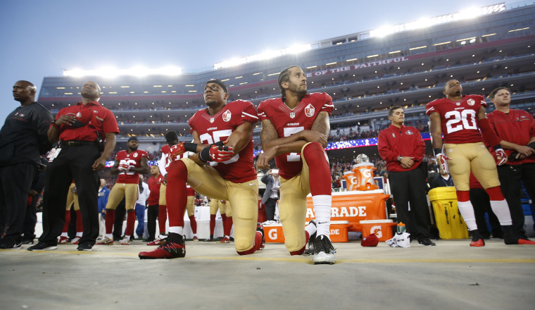 Image: Eric Reid and Colin Kaepernick of the San Francisco 49ers kneel during the national anthem in Santa Clara, Calif., in 2016.