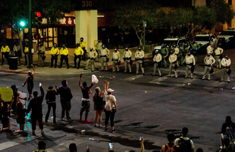 Officers line up in front of demonstrators on June 1, 2020, in downtown Las Vegas.