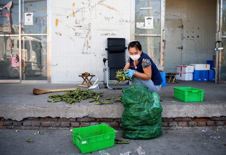 Image: A worker arranges vegetable at the closed Xinfadi Market in Beijing