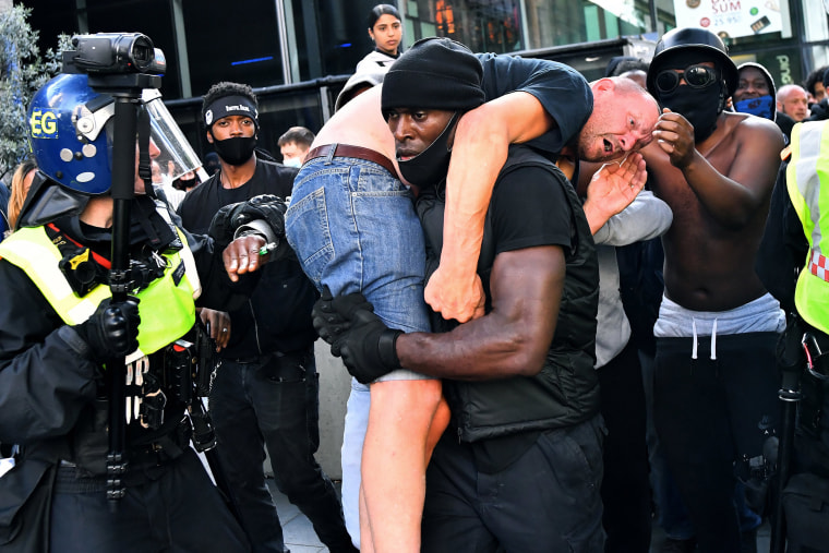 Image: Patrick Hutchinson, a protester, carries a suspected far-right counter-protester who was injured, to safety, near Waterloo station during a Black Lives Matter protest