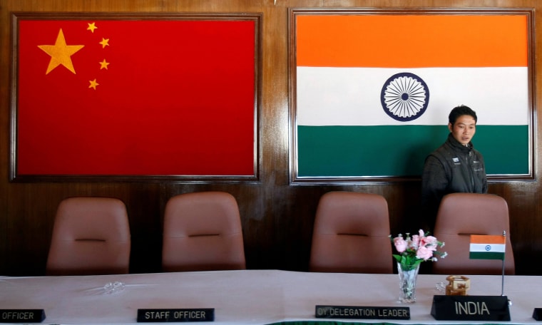 Image: A man walks inside a conference room used for meetings between military commanders of China and India, at the Indian side of the Indo-China border at Bumla, in the northeastern Indian state of Arunachal Pradesh.