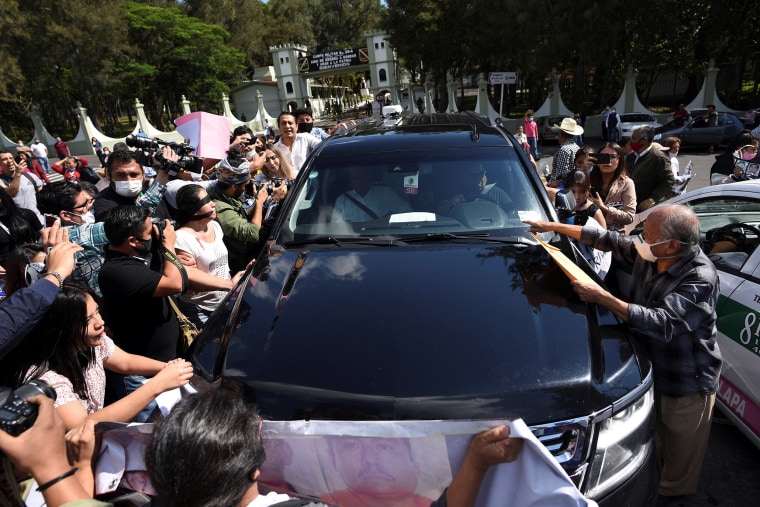 Image: Relatives of missing people surround the vehicle transporting Mexico's President Andres Manuel Lopez Obrador to ask him to stop and step down to talk to them, outside the 26-A Military Camp in El Lencero