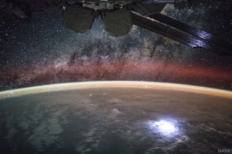 The airglow appears orange and hovers over the curve of the Earth, as seen from the ISS in 2012.