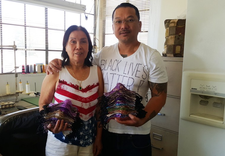 Van Huynh sews masks with his mother Cuong Thi Tran