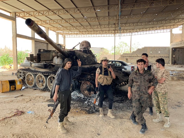 Image: Fighters loyal to Libya's internationally recognised government celebrate after regaining control over Tripoli