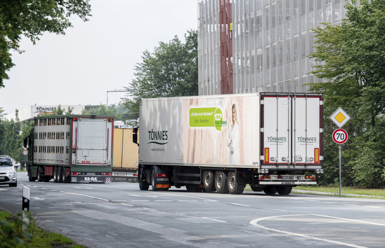 Image: Trucks leave the Toennies meatpacking plant in Rheda-Wiedenbrueck, Germany,