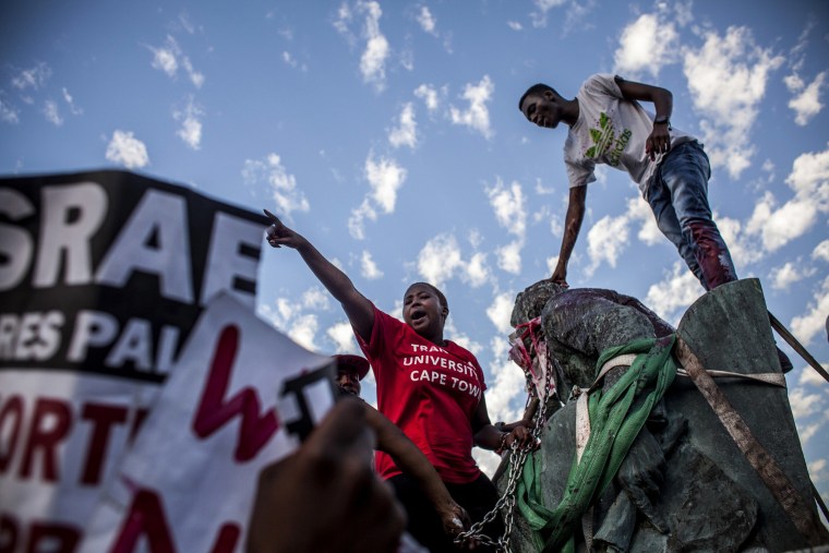 Image: Students cheer after the Cecil Rhodes statue is removed from the University of Cape Town