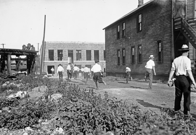 Mob running with bricks during Chicago Race Riots of 1919