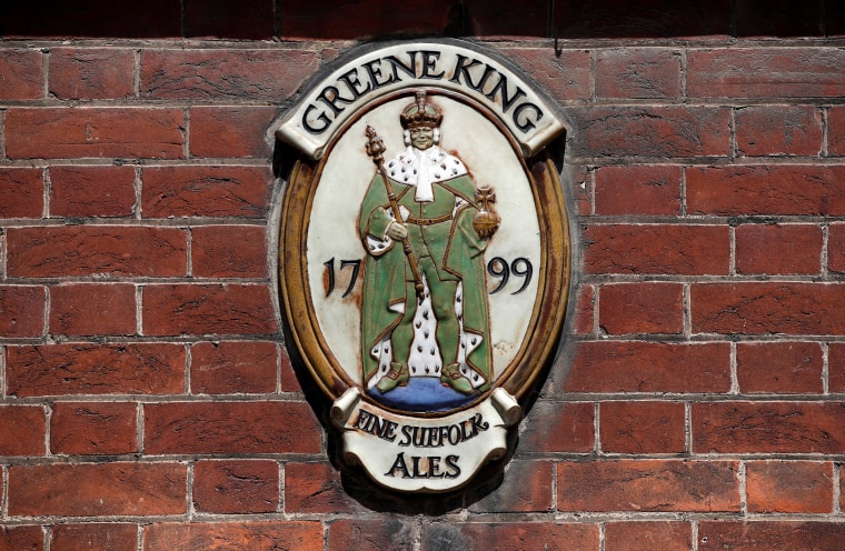 Image: A Greene King plaque outside its brewery and headquarters in Bury St Edmunds, Suffolk, Britain