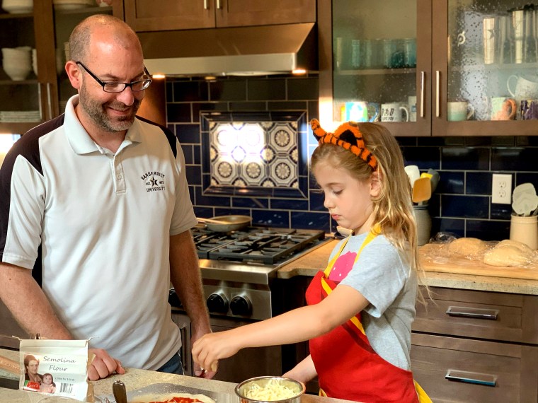 Chris Murdock and his daughter cooking in the kitchen.