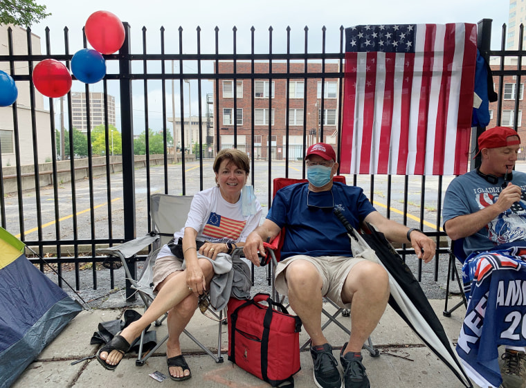 Mary and Ken Legan sit in line for President Donald Trump's Saturday rally in Tulsa, Okla.