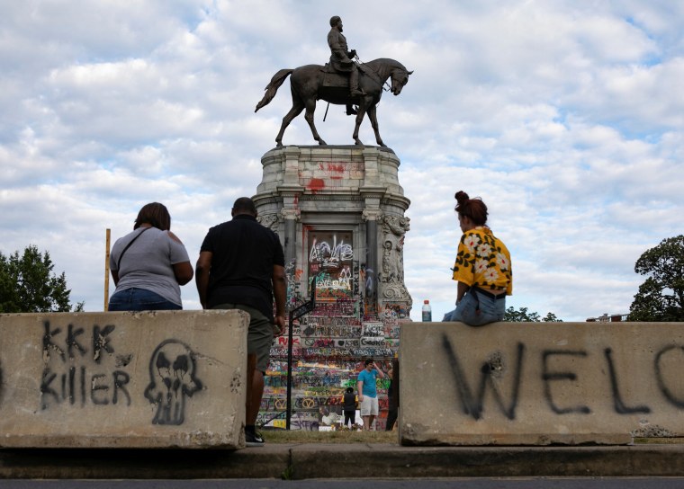 Image: People congregate around the base of the monument to Confederate General Robert E. Lee in Richmond