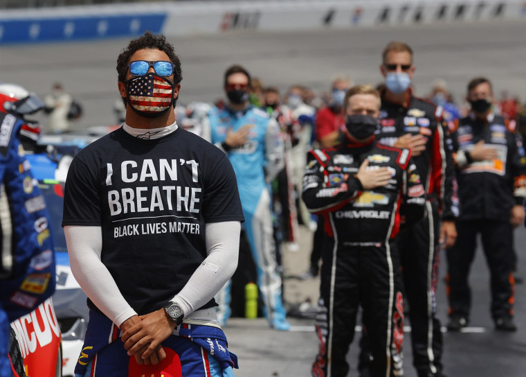Bubba Wallace wears an "I Can't Breathe — Black Lives Matter" T-shirt under his fire suit in solidarity with protesters during the national anthem before the NASCAR Cup Series Folds of Honor QuikTrip 500 at Atlanta Motor Speedway in Hampton, Ga., on June 7, 2020.