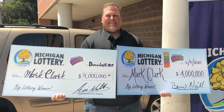 Mark Clark of South Rockwood, Michigan shows off his two wins for a $4 million instant game. 