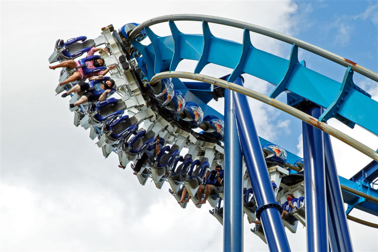 Tourists wearing face masks ride the roller coaster at SeaWorld San Antonio in Texas on June 19.