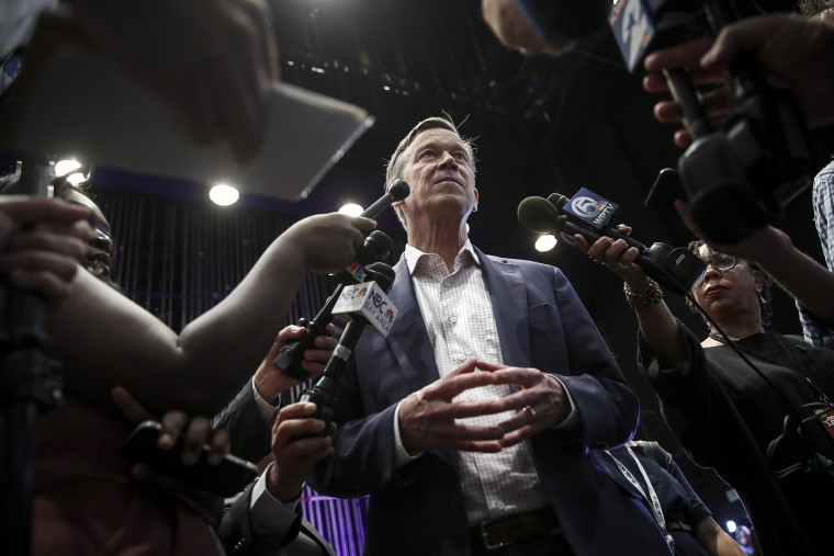 Image: Former Colorado Gov. John Hickenlooper speaks to reporters ahead of the first Democratic presidential primary debate in Miami