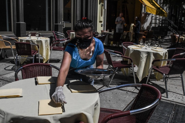 Image: An employee sets a table outside of the Cipriani restaurant in New York as the city begins phase 2 of its reopening on June 22, 2020.