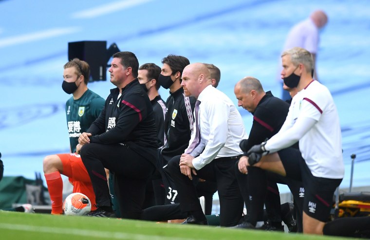 Image: Sean Dyche, Manager of Burnley takes a knee in support of the Black Lives Matter movement during the Premier League match between Manchester City and Burnley FC at Etihad Stadium on June 22, 2020 in Mancheste