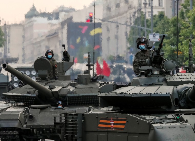 Image: Russian servicemen ride tanks before a rehearsal for the Victory Day parade in Moscow