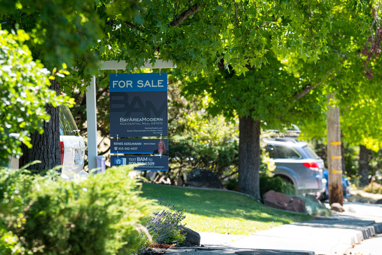 A \"For Sale\" sign stands in front of a single family home in San Rafael