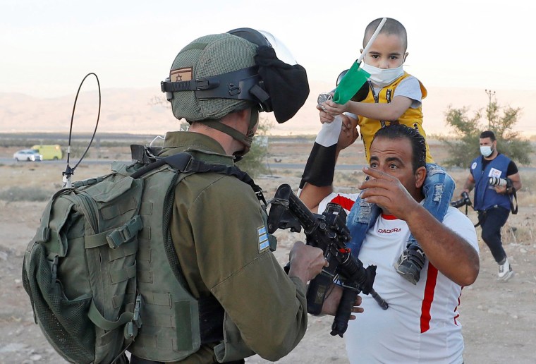 Image: A Palestinian man argues with an Israeli soldier