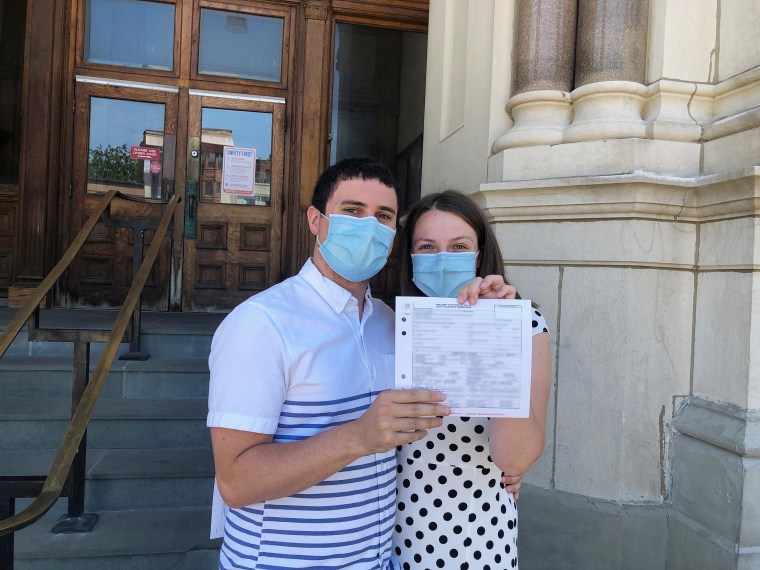 The bride and groom with their marriage license.