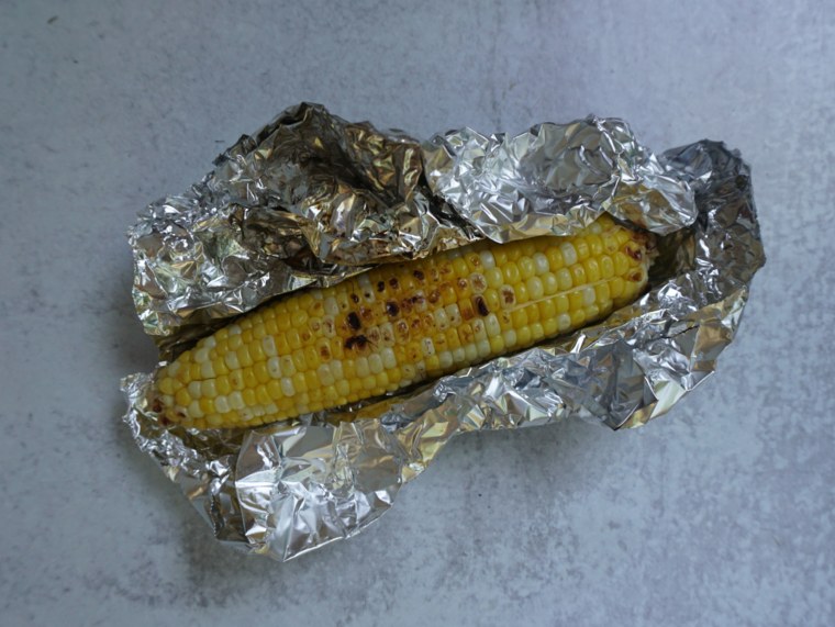 Corn wrapped in foil won’t have as much charred flavor as it would cooked directly on the grill, but the upside is that you can infuse it with flavors.