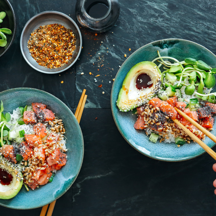 Man eating poke bowls with ponzu dressing