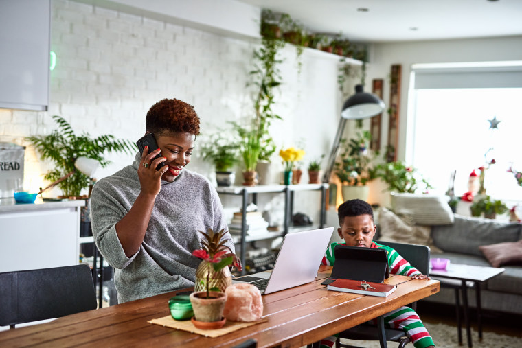 Mother looking after son and working from home