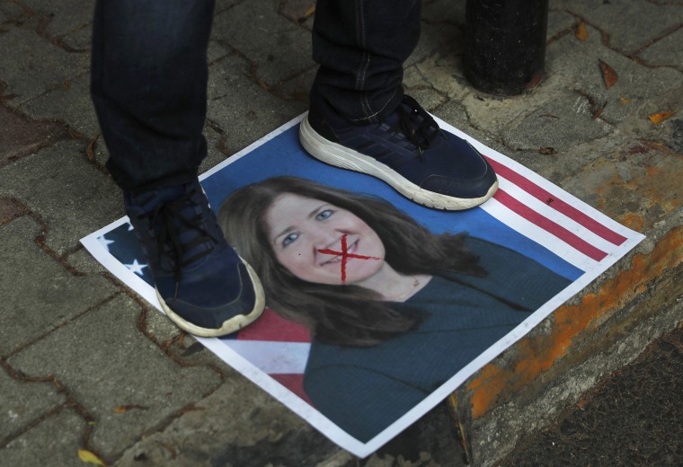 Image: A protester stands on a portrait of the U.S. Ambassador to Lebanon Dorothy Shea, outside the Lebanese Foreign Ministry on Monday.