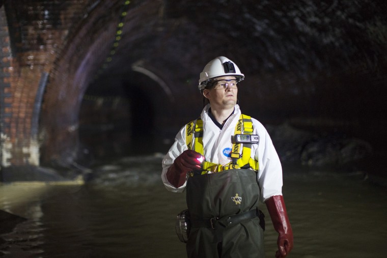 Image: An operations manager inside a sewer in London.