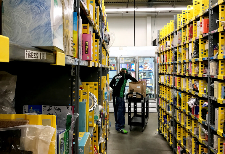 An employee collects items ordered by Amazon.com customers through the company's two-hour delivery service Prime Now in a warehouse in San Francisco