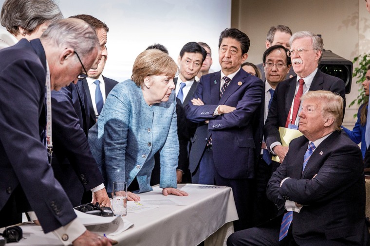 Image: German Chancellor Merkel speaks to U.S. President Trump during the second day of the G7 meeting in Charlevoix city of La Malbaie, Quebec