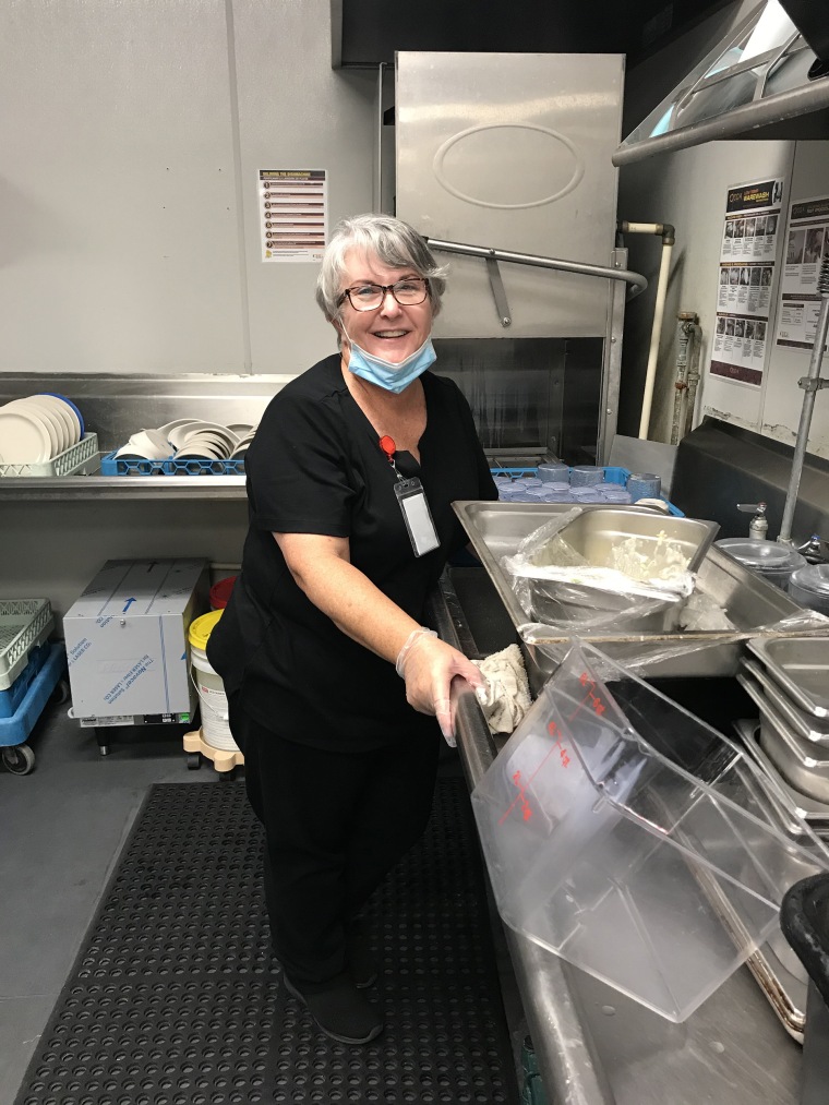 Mary Daniel says she doesn't mind her dishwashing job at the Rosecastle at Deerwood care center in Jacksonville, Florida because it gives her the chance to see her husband, Steve Daniel, who lives at the memory care center.
