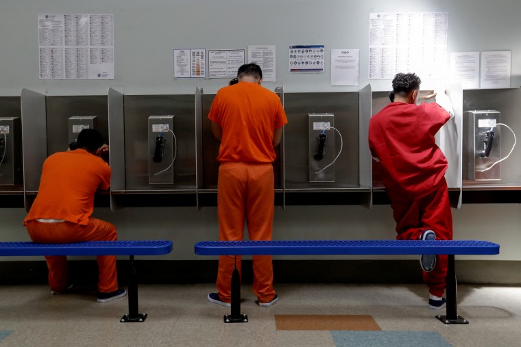 Detainees talk on the phones at the Adelanto ICE Processing Center in Adelanto, Calif. on Aug. 28, 2019.