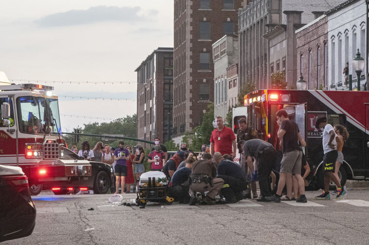 Paramedics, firefighters and law enforcement officers tend to a protester who was struck by a car following a Black Lives Matter protest in downtown Bloomington, Ind., on July 6, 2020.