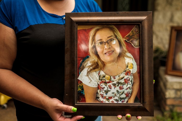 Image: Karen Salazar holds a picture of her mother, Felipa Medell?n, outside of her mother's home in Houston on July 7, 2020.