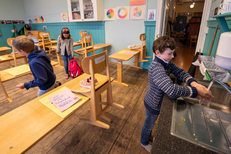 Image: 3rd grader Solen Ostermann at Nordstrand Steinerskole school in Oslo washes his hands after the school reopened